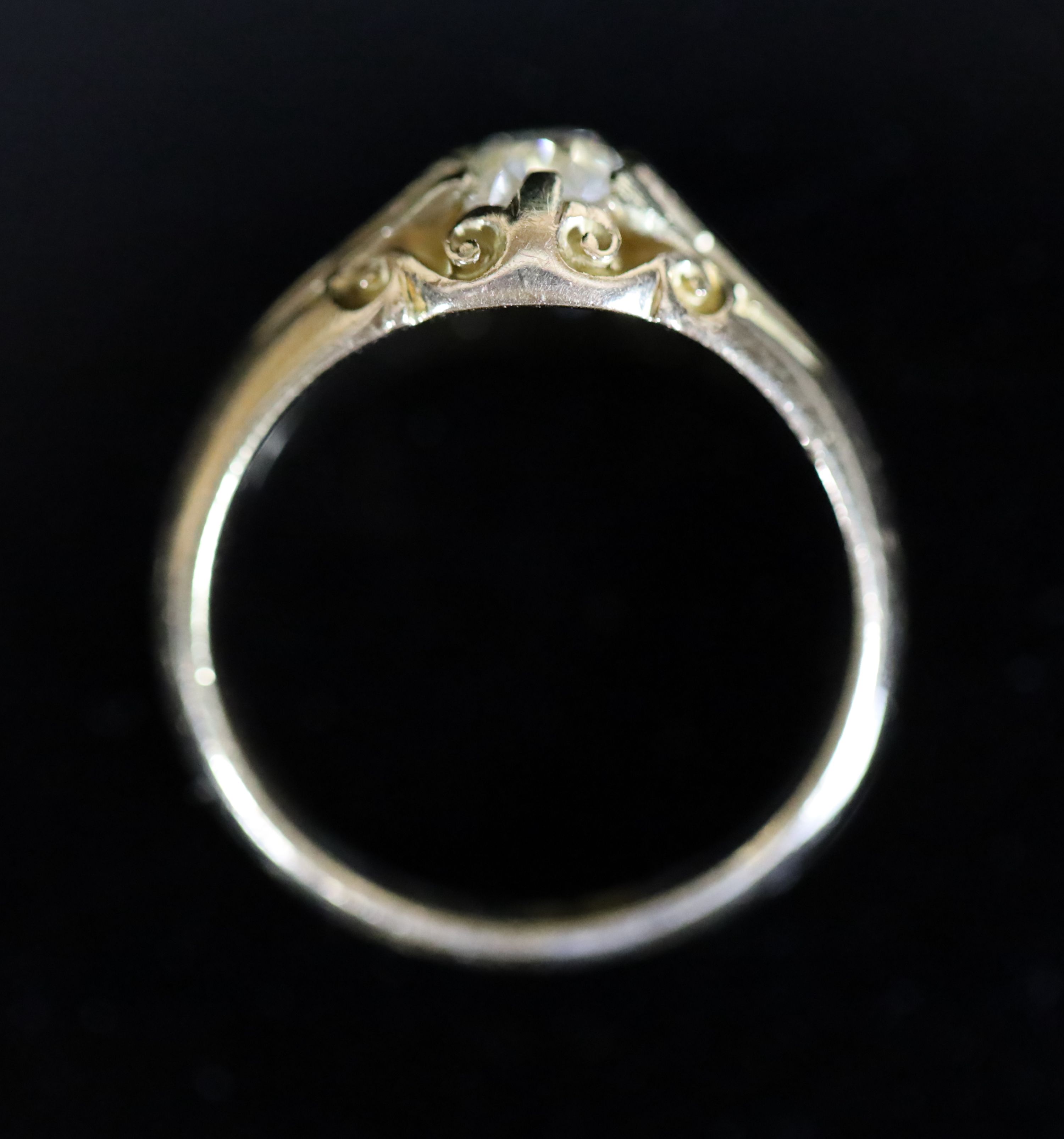 An early 20th century 18ct gold and claw set solitaire diamond ring